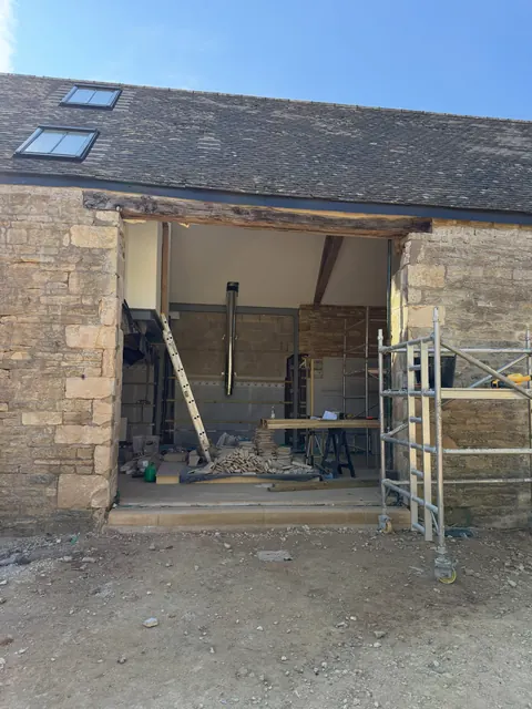 The empty barn opening, with scaffold tower, before the doors were fitted