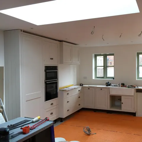 The kitchen units being fitted, with levels and tools on site